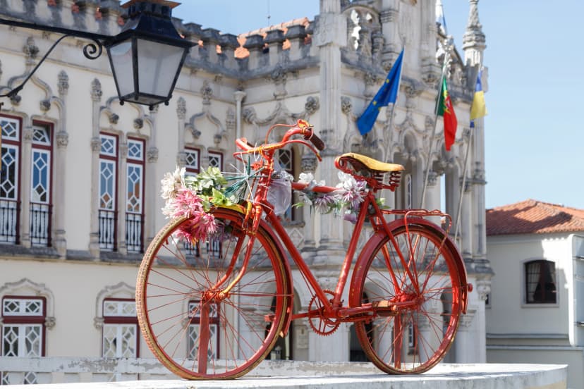 Sintra / Portugal. Old bicycle decorated with flowers on the square in front of the Town Hall in Sintra, Portugal.